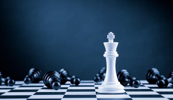 Black and white chess pieces on a black and white chess board